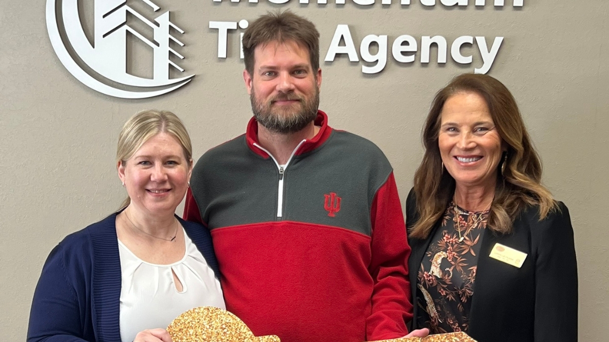 Linda with clients at closing