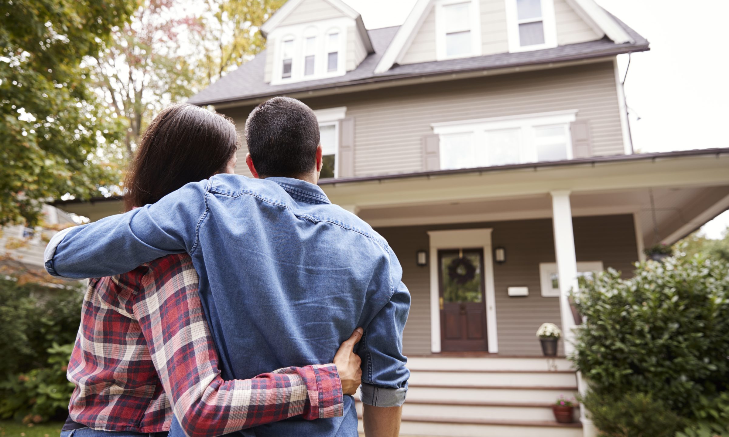 Happy buyers with sold sign